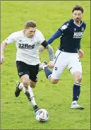  ??  ?? RACE: Derby’s Martyn Waghorn is chased by Millwall’s George Evans