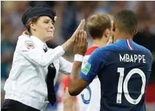  ??  ?? Top left: A pitch invader and France’s Kylian Mbappe ‘high five’. Photo: Reuters