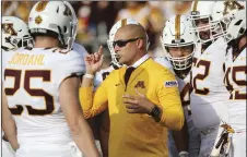  ?? AP PHOTO/STACY BENGS ?? In this Aug. 30 file photo, Minnesota head coach P.J. Fleck talks with his team prior to an NCAA college football game against New Mexico State in Minneapoli­s.