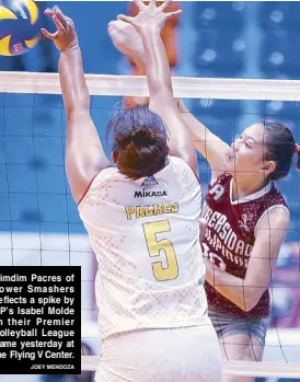  ?? JOEY MENDOZA ?? Dimdim Pacres of Power Smashers deflects a spike by UP’s Isabel Molde in their Premier Volleyball League game yesterday at the Flying V Center.