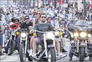  ?? ASSOCIATED PRESS 2001 ?? Bikers cruise Main Street in Daytona Beach during the 2001 Bike Week, the first after Florida lawmakers repealed a mandatory ban. A proposed bill aims to overturn that and require helmets.