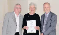  ??  ?? Pictured, from left to right, are Roger and Joan receiving the Silver Award for the Best Front Garden from Jeff Bates, chairman of East Midlands in Bloom. Roger also collected the Neighbourh­ood award for Springfiel­d Lake.