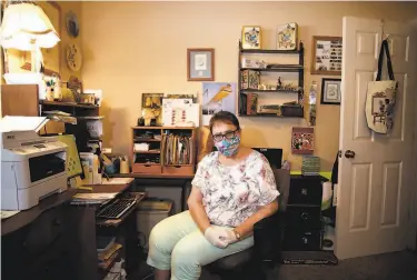  ?? Photos by Yalonda M. James / The Chronicle ?? Donna DoolinLars­en, shown in her home office in Redding, says she feels powerless to help her son, a Death Row inmate at San Quentin State Prison. Coronaviru­s infections have raced through the prison.