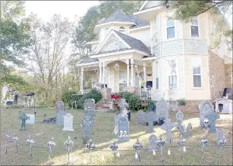  ?? Keith Bryant/The Weekly Vista ?? Teah Bidwell’s home, at the intersecti­on of Sandridge Drive and Theodore Drive, is decorated with headstones and skeletons, including skeletons on the ground and climbing on the house.