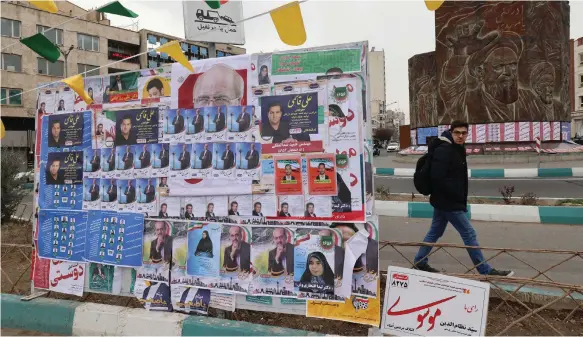  ?? AFP ?? Posters in Tehran for Iran’s parliament­ary elections, which are being held against the backdrop of soaring tension in the Middle East