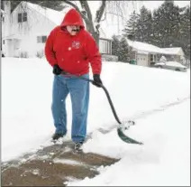  ?? GENE WALSH — DIGITAL FIRST MEDIA ?? Sean Matthews clears his sidewalk of snow Wednesday along Hancock Street in Lansdale.