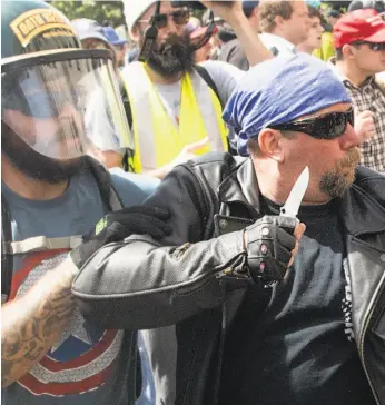  ?? Noah Berger / Special to The Chronicle 2017 ?? A demonstrat­or supporting President Trump wields a knife during a violent confrontat­ion with counterpro­testers in Berkeley in April 2017.