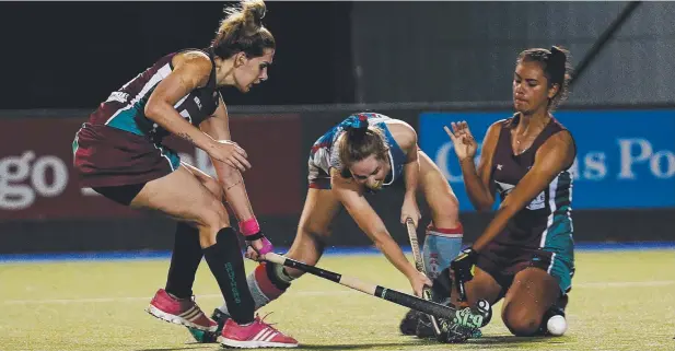  ?? Pictures: STEWART McCLEAN ?? SCRAMBLE: Saints' Jedess Hudson takes a shot at goal under pressure from Brothers' Megan Boston and Jessica Fatnowna.