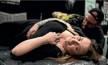  ?? ?? Palmerston North’s Brydee Cuthbertso­n gets a tattoo every time she comes to the festival.
Anastasia Storie-cole, left, of Hamilton, came to check out
Australasi­a’s biggest tattoo event.