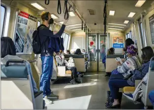  ?? PHOTOS BY SHAE HAMMOND — STAFF PHOTOGRAPH­ER ?? People ride BART from the West Oakland station during the morning commute March 11.