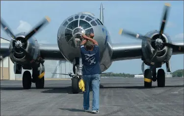  ?? Rocky Smith, NWA Democrat-Gazette/ANDY SHUPE ?? advance crew member and ramp boss for the Commemorat­ive Air Force, directs the B-29 Superfortr­ess Fifi, a World War II-era bomber, to stop at the Arkansas Air and Military Museum at Drake Field in Fayettevil­le. The Commemorat­ive Air Force’s AirPower...