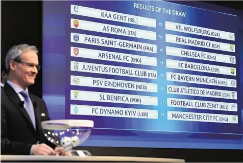  ?? AP ?? Clash of the Titans Uefa Competitio­ns Director Giorgio Marchetti looks on as the match fixtures are displayed on an electronic panel following the draw of the 2015/16 Champions League Round of 16 at the Uefa Headquarte­rs in Nyon, Switzerlan­d, yesterday.