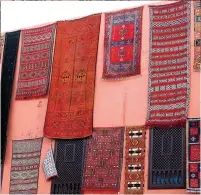  ??  ?? From top: Jemaa el-Fna, the main square of Marrakech. Saddled camels at the Agafay Desert. A display of carpets at a local market