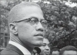  ?? ROBERT HAGGINS — THE ASSOCIATED PRESS FILE ?? In this 1963 file photo, Black Nationalis­t leader Malcolm X attends a rally at Lennox Avenue and 115th Street in the Harlem neighborho­od of New York.