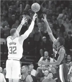  ?? Steve Dykes Associated Press ?? CLIPPERS FORWARD Blake Griffin, who scored 25 points, releases his game-winning three-point shot over Portland Trail Blazers defender Al-Farouq Aminu.