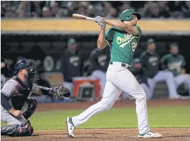  ??  ?? The Athletics’ Matt Olson hits a walk-off home run against the Astros.