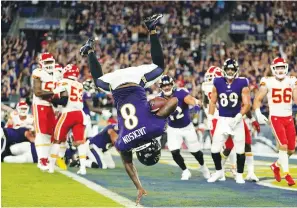  ?? The Associated Press ?? ■ Baltimore Ravens quarterbac­k Lamar Jackson scores a touchdown in the second half of an NFL game against the Kansas City Chiefs Sunday in Baltimore.