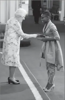  ??  ?? Marva Langevine receives her Young Leaders Award from Queen Elizabeth II