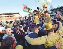  ?? AFP ?? Supporters and players of Dalkurd FF celebrate after the club’s promotion to Swedish football’s top division after their victory against Gothenburg’s GAIS on October 28.