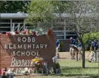  ?? Jae C. Hong/Associated Press ?? Investigat­ors search for evidence outside Robb Elementary School in Uvalde, Texas, on Wednesday.