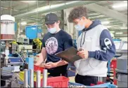  ?? Erin Gray Cantrell ?? Students Joseph Wallace (left) and Adrian Zavala go over a mechanical checklist Tuesday while interning at Suhner Manufactur­ing through FCS’ College and Career Academy.