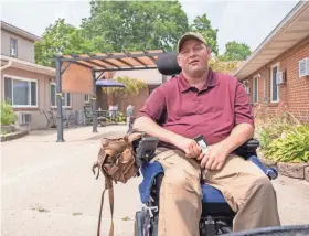  ?? INDYSTAR FILE ?? Travis Shinneman sits in the Ambassador Healthcare courtyard on July 29, 2021, in Centervill­e. Shinneman went into a Marion County Sheriff’s Office vehicle non-disabled and left a quadripleg­ic, according to his lawyers.