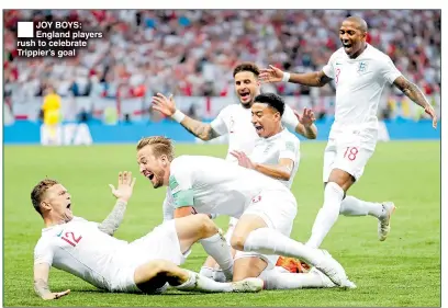  ??  ?? JOY BOYS: England players rush to celebrate Trippier’s goal