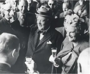  ??  ?? Above: Winston Churchill with his wife Clementine, making a toast on their arrival in Switzerlan­d in 1946