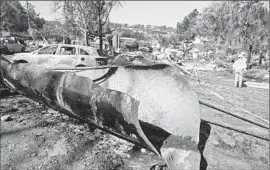  ?? Don Bartletti
Los Angeles Times ?? A SECTION of natural gas pipeline that landed on Glenview Drive in San Bruno, Calif., is shown after the September 2010 explosion that killed eight people.