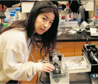  ?? DOMINIC ALI / UNIVERSITY OF TORONTO ?? University of Toronto PhD student Lian Leng works with a prototype printer that is capable of extruding multiple layers of a skin-like material that could one day be used to replace current skin grafting methods.