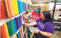  ?? CHARLIE NEUMAN ?? Chris Tracy (left) and her daughter Svea Komori-ang, of Dancing Bear Indian Trader, fill an online bead order this month.