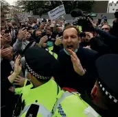  ??  ?? Former Chelsea goalkeeper Petr Cech, right, tries to calm protesting fans before the London club’s match against Brighton yesterdat.