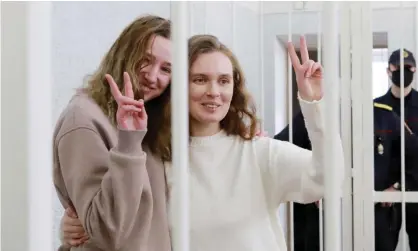  ?? Photograph: AFP/Getty Images ?? Katsiaryna Andreyeva, right, and Darya Chultsova make ‘V’ signs from cage in court on Thursday.