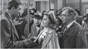  ?? AP FILE PHOTO ?? James Stewart, left, Thomas Mitchell, right, and Donna Reed appear in a scene from the 1946 film It’s A Wonderful Life.
