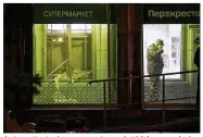  ?? DMITRI LOVETSKY / AP ?? An investigat­or is on scene at a market hit by an explosion Wednesday in St. Petersburg, Russia. The explosive device was rigged with shrapnel.