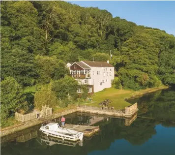 ??  ?? Above: The Old Sawmills stands in a private inlet on the River Fowey, Cornwall. £2.25m Below: The immaculate Georgian-style Lea House near Lymington, Hampshire. £8.5m