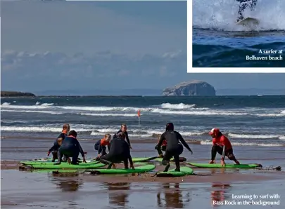  ??  ?? Learning to surf with Bass Rock in the background