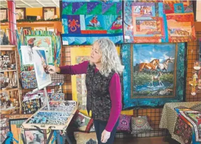  ?? Photos by Helen H. Richardson, The Denver Post ?? Mancos artist Linda Bonds works on a pastel piece at the Artisans of Mancos co-op, a group establishe­d in 2003. The Mancos Creative District spans several blocks in the historic downtown area.