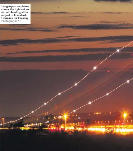  ??  ?? Long exposure picture shows the lights of an aircraft landing at the airport in Frankfurt, Germany on Tuesday Photograph: AP
