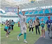  ?? JOHN MCCALL/SUN SENTINEL ?? Dolphins quarterbac­k Brock Osweiler walks off the field after defeating the Bears on Sunday in overtime.