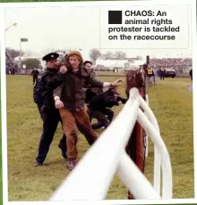  ?? ?? ■ CHAOS: An animal rights protester is tackled on the racecourse