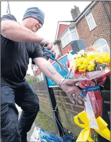  ??  ?? DESTROYED: A man turns up to rip down the flowers