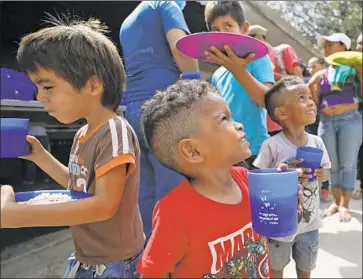  ?? Fernando Vergara Associated Press ?? YOUNG Venezuelan­s get a free lunch at a shelter near Cucuta in Colombia. The border city has become a hub for intensifyi­ng U.S. efforts to oust Venezuelan President Nicolas Maduro and his socialist government.