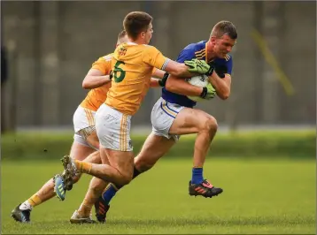  ??  ?? Rory Finn in action against James McAuley (6) and Kevin Quinn of Antrim during the Allianz Football League Division 4 Round 6 match between Wicklow and Antrim in Aughrim.
