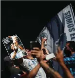  ?? RICARDO MORAES/REUTERS ?? A man, holding a Diego Maradona picture, shouts as people gather to mourn the death of the football legend outside the Casa Rosada presidenti­al palace, Buenos Aires, Argentina, on November 26, 2020.