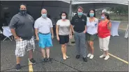  ?? BOB CANNON VIA FACEBOOK ?? Clinton Township Supervisor Bob Cannon, third from right, poses with others during Sunday’s “casual cruise” event before heavy rain forced them to cancel.