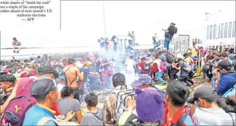  ??  ?? Honduran migrants rush through the Guatemala-Mexico internatio­nal border bridge, in Ciudad Hidalgo, Chiapas state, Mexico.