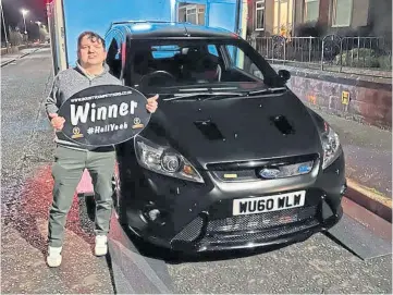  ?? ?? LUCKY DAY: Michael Anderson with the Ford Focus RS500 he won with a £5 ticket.