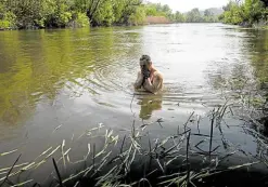  ?? —PHOTOS BY AFP ?? TROUBLED WATERS A Ukrainian soldier swims at the Siverskyi Donets in Mayaky, eastern Ukraine.