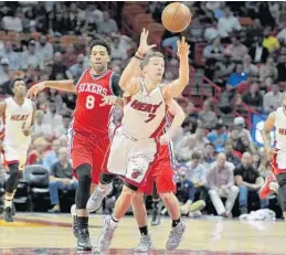  ?? MICHAEL LAUGHLIN/STAFF PHOTOGRAPH­ER ?? The Heat’s Goran Dragic throws up a half-court shot after being fouled by Philadelph­ia’s T.J. McConnell during the first half Wednesday at AmericanAi­rlines Arena.